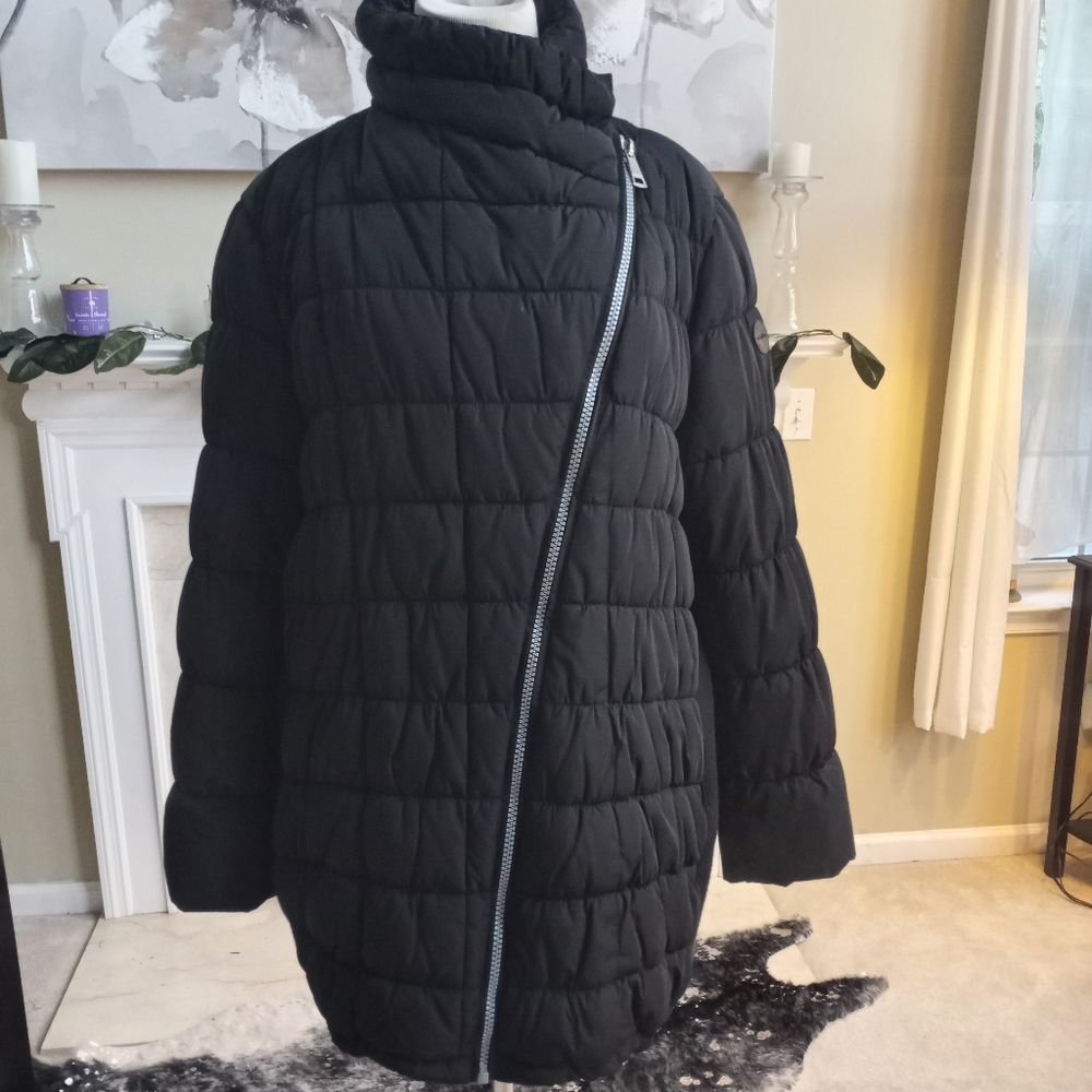 Calvin Klein black asymmetrical puffer jacket with knit side panels.